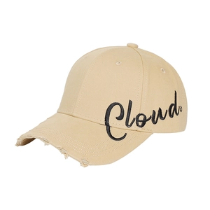 Beige baseball cap with Cloud embroidery and distressed brim in a 45-degree view