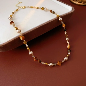 Macro shot of S925 silver clasp on tiger eye beaded necklace with Maillard style beads