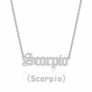 Close-up of silver Gothic Scorpio letter pendant on a stainless steel link chain