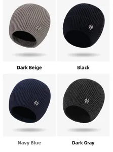 Detail view of four-color knitted beanies featuring vertical stripes and metal logos