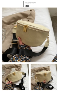 Detail of off-white lychee pattern leather waist bag with gold zippers and wide strap