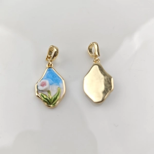 Detailed macro of golden rose flower pendant with oil-dripping painted finish