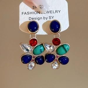 Macro detail of S925 silver vintage drop earrings with colorful multi-stone crystal inlay