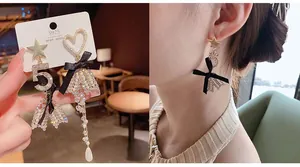 Detail of asymmetric pearl earrings with bow and S925 silver needle on model
