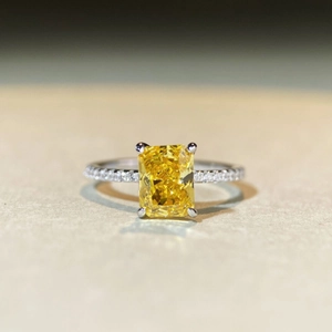 Macro view of radiant cut yellow gemstone ring with S925 sterling silver band