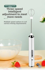 Detail of white cordless electric milk frother with stainless steel whisk on wood