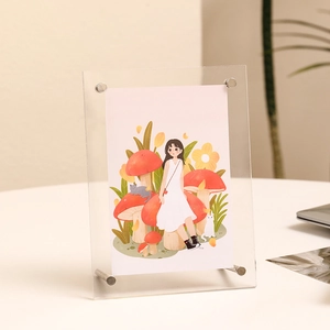 Minimalist double-sided acrylic photo frame with silver metal legs for tabletop display