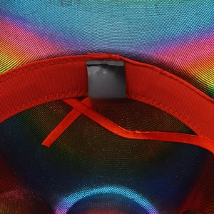Detailed interior of rainbow cowboy hat showing red sweatband and cotton fabric labels