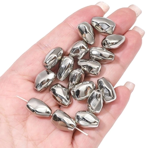 Close-up of irregular silver CCB star beads for DIY jewelry making held in hand