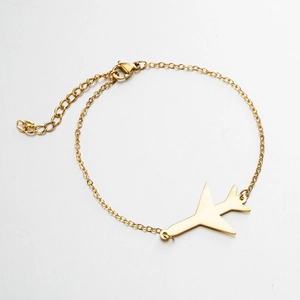 Detail of gold-plated stainless steel chain featuring an airplane charm and lobster clasp
