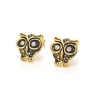 Boucles d'oreilles hibou vintage or et noir avec yeux en cristal sur fond blanc