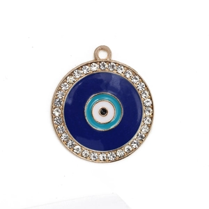 Macro detail of a golden evil eye pendant featuring blue enamel and sparkling white zircons