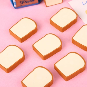 Cute toast sliced bread erasers set in brown and beige on a soft pink background