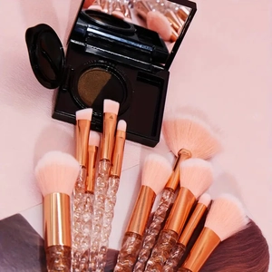 Macro detail of professional makeup brushes with rose gold ferrules and pink bristles