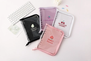 Flat lay of transparent glitter A5 binder covers with colorful fruit designs