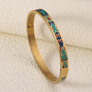 Macro detail of the colorful enamel patterns on the vintage 18K gold plated steel bangle