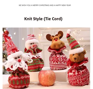 Detailed view of four knitted Christmas drawstring gift bags featuring Santa and reindeer