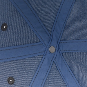Macro shot of the six-panel interior crown and stitching on the denim baseball cap