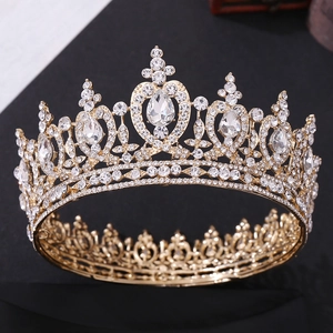 Luxurious bridal crown with gold metal and heart-shaped crystals on dark background