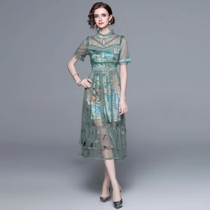 Elegant green mesh maxi dress with embroidery and beaded details on a studio model