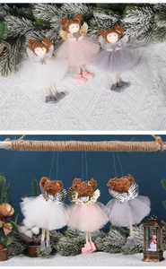 Detailed view of Christmas angel ornaments with mesh skirts and shiny metal wings