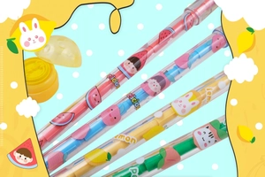 Detail of cartoon fruit bullet pencils featuring stamps, whistles and colorful patterns