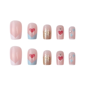 Pink French press-on nails with blue accents, red hearts, and sparkling rhinestones