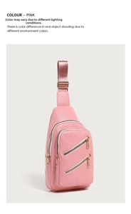 Detailed view of pink PU leather sling bag featuring dual diagonal zippers and gold hardware