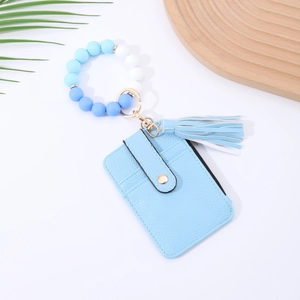 Close-up of a blue silicone bead bracelet with a matching leather tassel and card holder