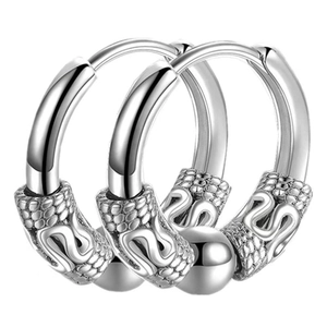 Detail view of silver stainless steel hoop earrings with vintage dragon scale texture