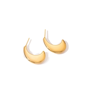 Macro detail of gold crescent moon stud earrings with a polished mirror finish