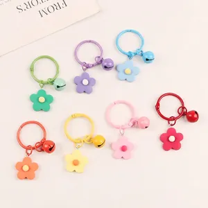 Set of seven colorful floral bell keychains with metal ring and matte flower pendants