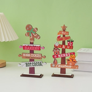 Close-up of wooden Christmas tree tabletop decor with gingerbread and bakery signs