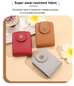 Detail of mini leather cosmetic bags in red and brown with sunflower metal buckles