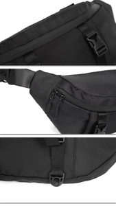 Detailed view of the durable plastic buckle and nylon fabric on the black tactical chest bag