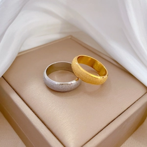 Minimalist frosted titanium steel rings in gold and silver finish on silk