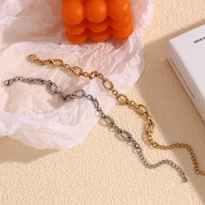 Detail of gold and silver large O-link chain bracelets with lobster clasps and extenders