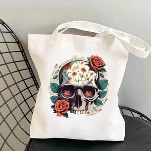 Close-up of skull and red rose floral print on white canvas tote bag detail