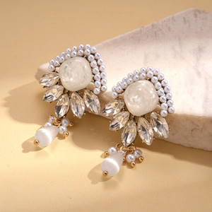 Elegant vintage geometric resin pearl earrings with crystal accents on marble surface