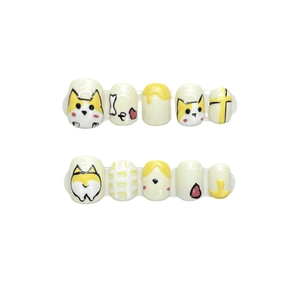 Handmade Corgi dog theme press-on nails in yellow and white featuring cartoon patterns