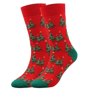 Detailed view of red and green knitted Christmas socks with small tree patterns