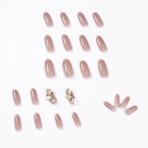 Pink gradient oval press-on nails with 3D gold butterfly charms and glossy finish