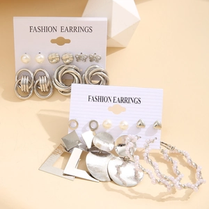 Detail view of silver alloy earring set featuring geometric shapes and faux pearls