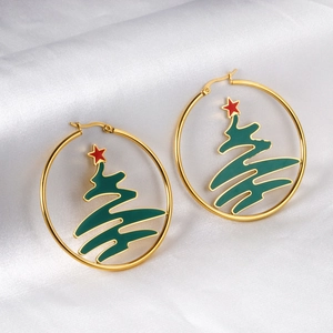 Detailed close-up of gold Christmas tree hoop earrings on elegant white silk background