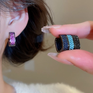 Close-up of pave square zircon ear hoops in pink, royal blue, sky blue and black