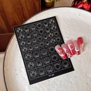 Christmas nail stickers set with wreath patterns and bows on a festive white display