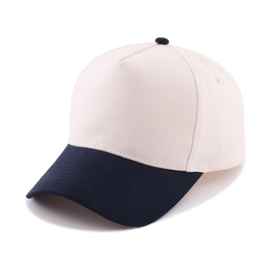 Close-up of a five-panel cotton baseball cap with beige crown and navy blue brim contrast