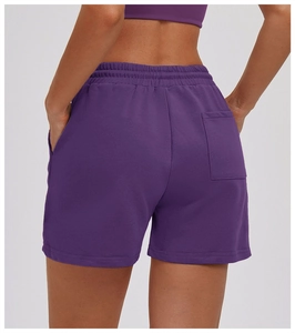 Detail view of the back pocket and elastic waistband on dark purple sports shorts
