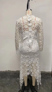 Detailed back view of white lace dress featuring invisible zipper and satin waist tie