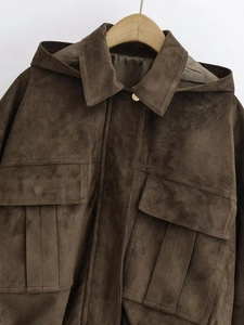Detailed view of suede bomber jacket hood with large flap pockets in dark coffee